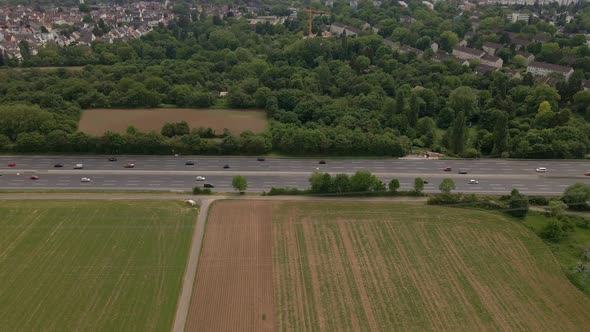 Numerous cars and trucks driving along the Autobahn A66 to and from Frankfurt am Main, Germany. Aeri