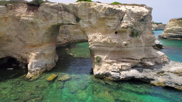 4K aerial of the rock formations of Sant'Andrea near Torre Dell'Orso, Apulia, Italy in the summer.