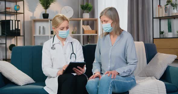 Doctor Explaining the Methods of Treatment Using Information on Tablet PC to Her Female Patient