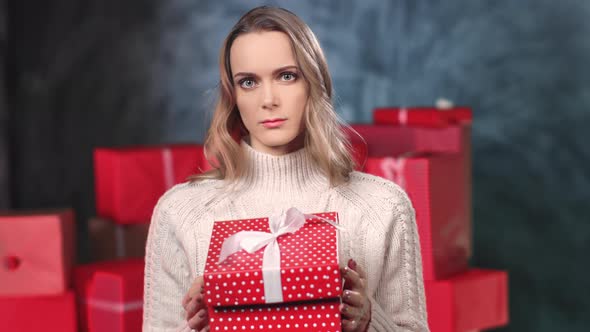 Portrait Frowning Woman Unpacking Unsatisfied Christmas Gift Box Upset Emotion Posing Gray Studio