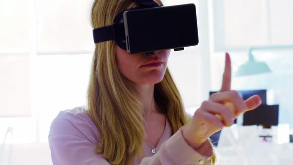 Female executive using virtual reality headset