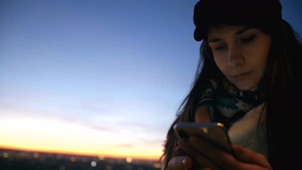 Low Angle Close-up Young Beautiful Local Woman Using Smartphone App at Incredible Bright Sunset