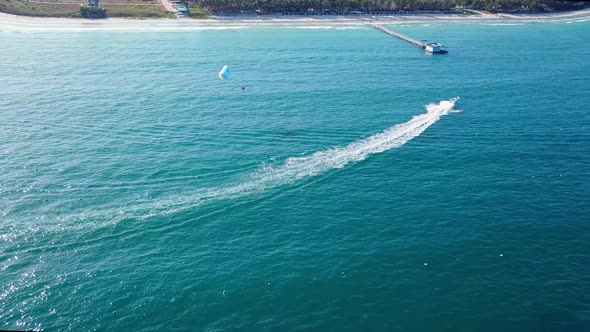 Tourists Parasailing Over Sea Coastline, Drone Point View.