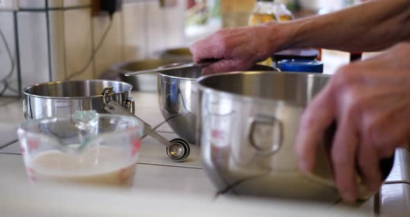 A woman chef preparing her dishes and ingredients for baking a vegan chocolate cake on a kitchen cou