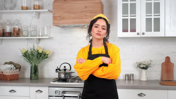 Portrait Serious Housewife Crossing Hands Looking Camera in Home Modern Kitchen