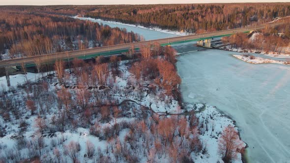 Tranquil Winter Landscape with Road Bridge at Sunset Aerial View