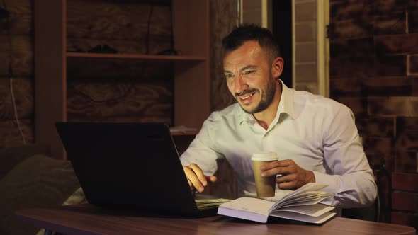 Smiling Businessman Drinking Coffee Showing on the Screen Grinning