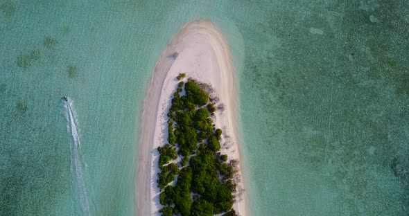 Luxury above tourism shot of a white paradise beach and blue sea background in hi res 4K