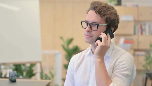 Portrait of Angry Young Man Talking on Smartphone