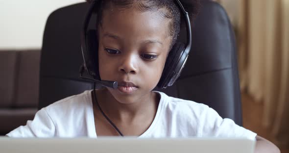 Little African Girl Plays at Laptop Child Pretends Call Manager, Schoolgirl Daughter Wears