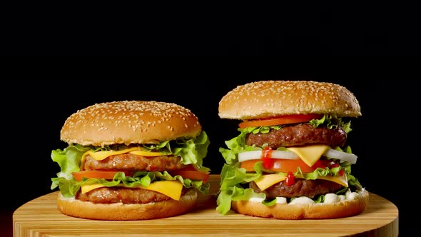 The Concept of American Fast Food. Juicy American Burger with Two Beef Cutlets, with Sauce and