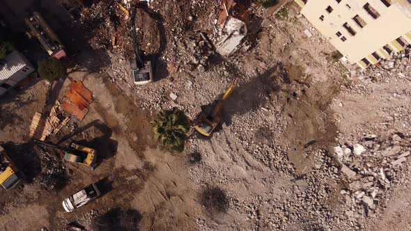 Aerial Drone View of Demounting Building By Two Heavy Excavators