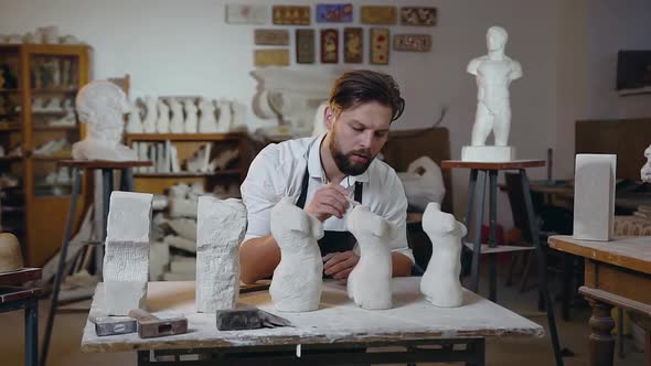 Sculptor with Beard which Sitting at His Workplace