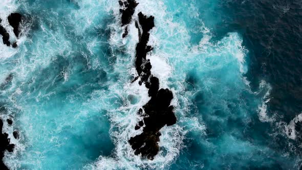 Aerial Rising Over Big Waves Crashing Into Cliffs Near the Shores of Madeira Island Portugal