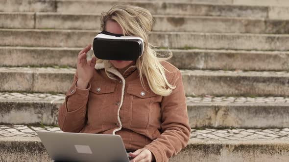 Slow Motion Shot of Young Woman with VR Glasses and Laptop