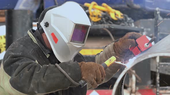 Welder Welds the Pipe