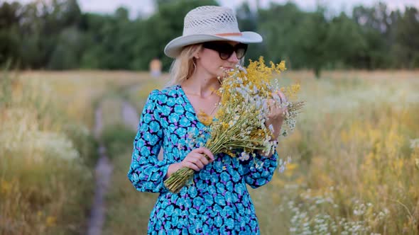 Woman Sniffs Flowers. Gathers Wildflowers On Field. Romantic Girl Gathering Flower. Sniff Bouquet.