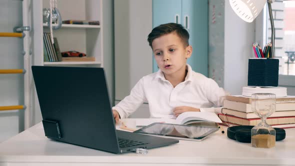 A Boy Is Talking During Online Class While Being at Home