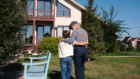 Rear View Video of Grandfather and Grandson Walking Towards Their House