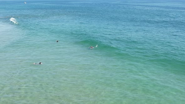 Surfer Rides A Wave