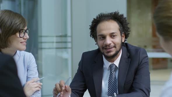 Middle Eastern Male Manager Talking to Colleagues at Meeting