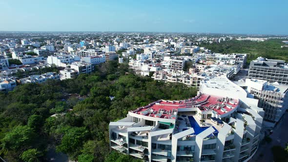 white hotels and apartment buildings in Playa Del Carmen coastline on sunny day, aerial