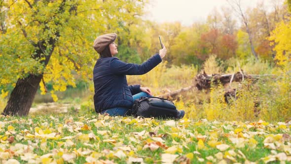 Girl Tourist on a Hike in the Autumn Forest