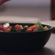 Slow Motion Man Hand Add Coppa Slices To Make Salad with Kale and Cherry Tomatoes in Black Bowl on - VideoHive Item for Sale
