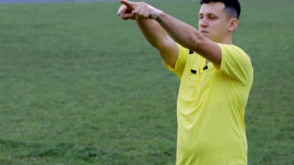 Referee goes watching VAR or violation of the rules and shows a penalty, yellow or red card 