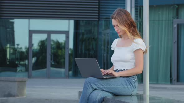 Focused Attractive Woman Journalist Freelancer Working Online Using Laptop Sitting Outdoor Looking