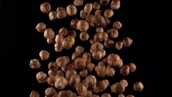 Hazelnuts in Free Fall on a Black Background