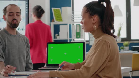 Close Up of Coworkers Using Laptop with Green Screen