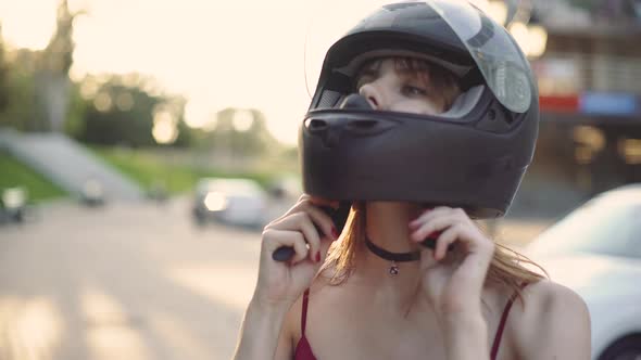 Beautiful Young Redhaired Woman Motorcyclist Dresses Her Black Helmet