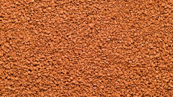 Full Frame Slowly Spinning Background of Freezedried Instant Coffee Granules Extreme Closeup View