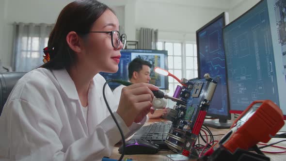 Asian Female Engineer Does Computer Motherboard Soldering. Scientists Design Industrial Pcb