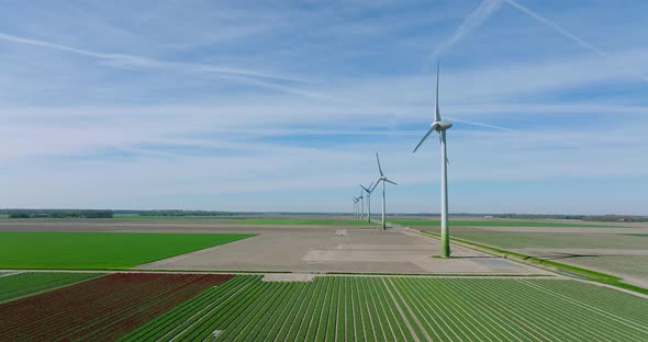 Wind turbines generating electricity in a flat Dutch landscape.