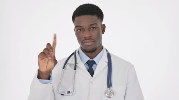 African Doctor Showing No Sign By Finger on White Background