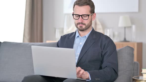 Young Businessman Using Laptop at Home