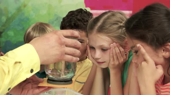 Excited Kids Watching Experiment with Water Close Up