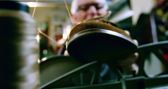 Shoemaker examining a shoe