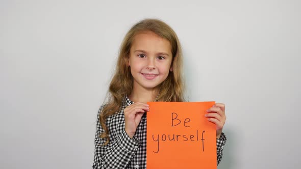 Happy Girl Showing Handwritten words Be Yourself