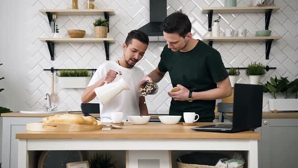 Gay Couple Preparing Breakfast in Kitchen at Morning