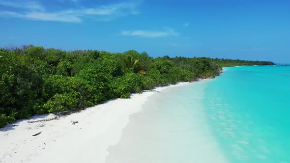 Aerial drone tourism of tranquil resort beach lifestyle by aqua blue sea and white sandy background 