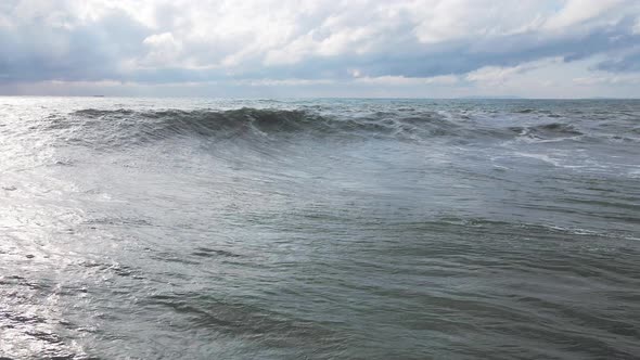 Powerful Waves Forming Breaking on the Shore and Splashing with White Foam