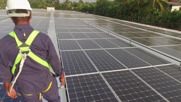 Worker On Solar Roof