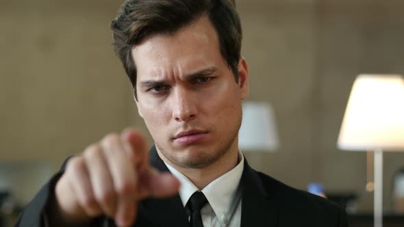 Angry Man Pointing toward Camera with Finger