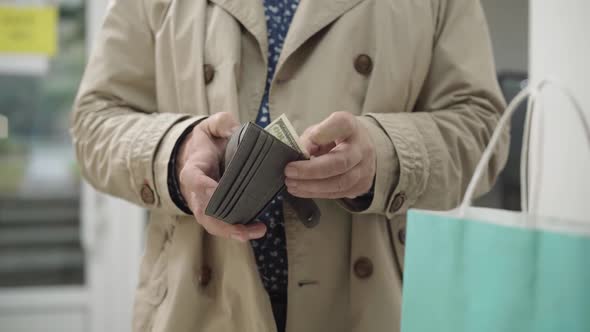 Wallet with Dollars in Male Senior Caucasian Hands. Unrecognizable Man Counting Money in Shop. Lack