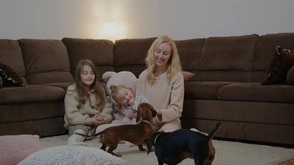 Mom on Floor with Little Daughter and Dog Play with Ball Rbbro