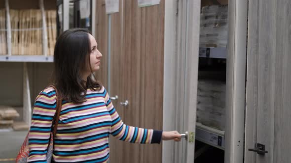 Woman Choosing Interroom Doors for Home in Store