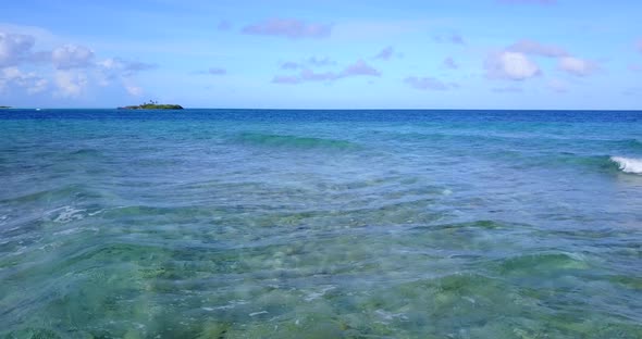 Wide angle overhead copy space shot of a paradise sunny white sand beach and aqua turquoise water 